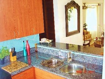 Luxurious Kitchen with Granite tops with a silky Blue Marble covered walls