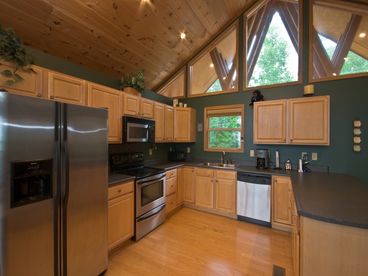 Large well-stocked Kitchen, with Peninsula for extra seating, cathedral ceiling, etc.