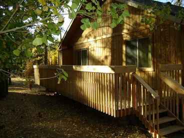 Enjoy a serene glass of wine on our private back deck with the wind whispering through the trees