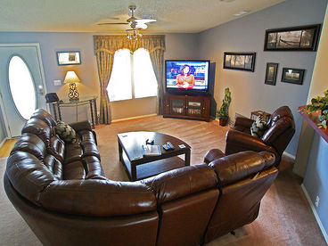 Family room with 55 inch HDTV and extensive dvd collection including over 100 Disney classics. The sumptuous leather suite has a reclining sofa and a reclining, rocking armchair.