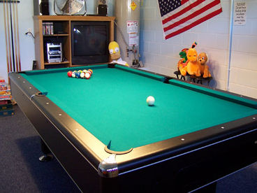 Great game room with slate bed pool table, air hockey, foosball and lots of games