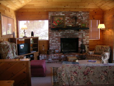 Cozy living room with wood burning fireplace.