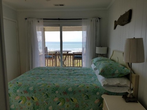Oceanfront Bedroom with bath. Deck access. Watch the sunrises and sunsets in the off season. Teak Bistro Table and chairs. Teak Rockers on Oceanfront deck