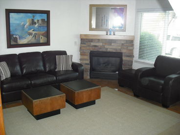 The cozy living room features a rock fireplace with a gas log.  A  32\
