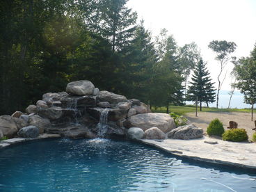 The outdoor pool with fountain and beach in background