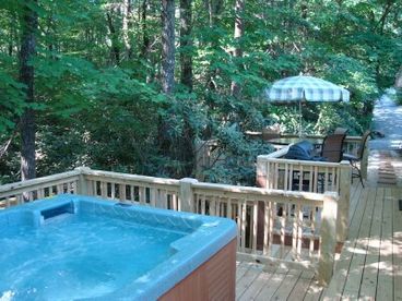 Nestled beside the Rhododendron forest is a powerful 6 person hot tub and second deck with 6 person patio table and chairs.  Stairs lead to the canyon below.