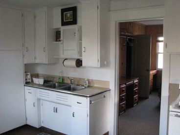 Clean and full kitchen. Hot and cold running water. Microwave, toaster, stove, refrigerator.  Table with four chairs