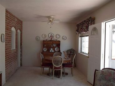 The dining area is located off the kitchen and seats four people.