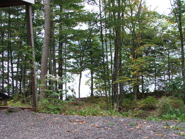 The view of Walker Pond from the driveway. Walker Pond is a protected Maine lake that is over 2 miles long and about 3/4 mile wide.