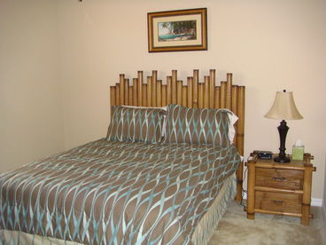 Lrg guest room with queen bed full closet, night stands and dresser and ceiling fan