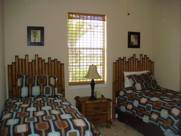 2nd guest room with 2 single beds night stand, full closet and dresser, ceiling fan