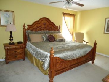master bedroom with king bed and inside bathroom