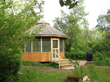 16-sided screened-in gazebo with gas grill and firepit on Laughing Whitefish River