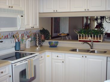 The kitchen has corian countertops, breakfast nook and is fully equipped with flat top range, water/ice in fridge door, microwave, garbage disposal, pantry, toaster, steamer, food processor, blender and so much more