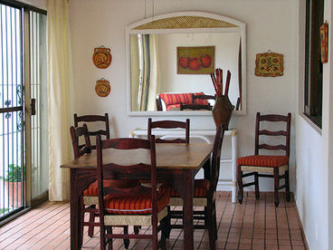 Dining area in sun room with large sliders for easy indoor - outdoor living.