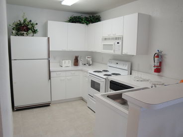 Fully equipped kitchen includes dishwasher, full size refrigerator, microwave, automatic coffee maker, blender, garbage disposal.