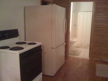 The kitchen appliances make this cabin both convenient and easy to use.  The bathroom is seen close to the kitchen.