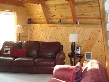 Large windows with sliding glass door open to a small covered porch.  Lots of light all year round.