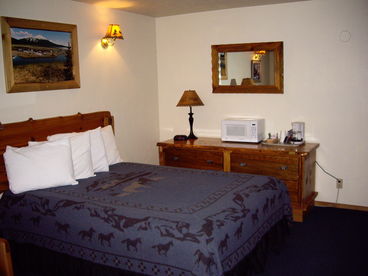 Large room with Queen bed, hideabed, fireplace and kitchenette.