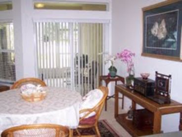 Dining room and living room open onto screened-in patio.