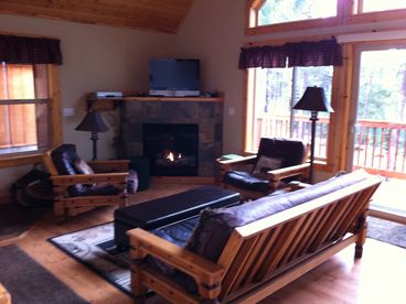 The great room is a wonderful place to relax with a cozy fire, watch movies, read, play games and enjoy the company of family and friends. The deck to the outdoors is just a few steps away.