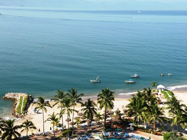 Private white sand beach with tons of lounge chairs provides the perfect place to relax