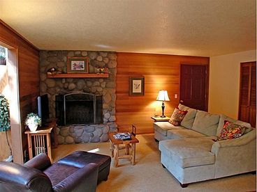 Living  room with river rock, wood burning fireplace.  