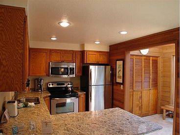 Updated kitchen with granite countertops and stainless steel appliances.  