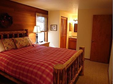 Master suite with adjoining master bath and log pine furniture throughout.  