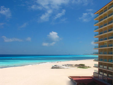 This is a view from Plaza Forum By The Sea Mall, located next door to the north.  It is looking south with our building to the right and shows our beach and water.