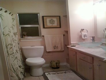 A great soaking tub with extended shower rod provide comfortable baths & showers