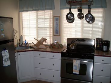 Full kitchen with stainless appliances, Keurig coffee maker, microwave, and fully stocked with kitchen essentials.