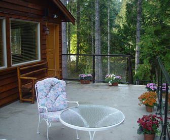 Cottage front deck overlooking gardens and lake.