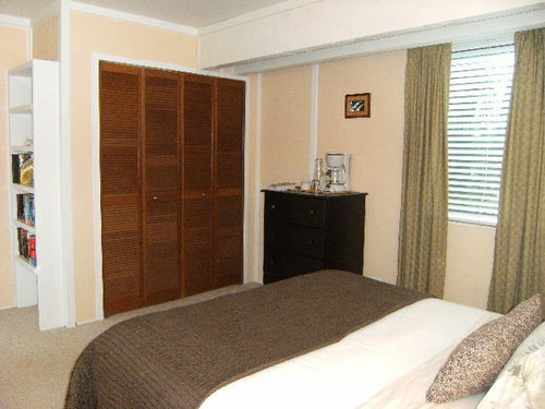 Cool spacious suite with closet, dresser, shelving, table and chairs, mini fridge