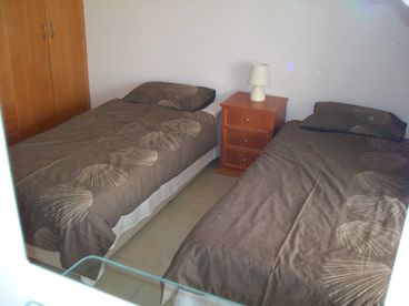 Comfortable bedroom with fully fitted wardrobes.