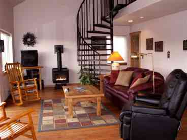 The open living room and spiral stairway.  The view windows look out to the Yellowstone River.