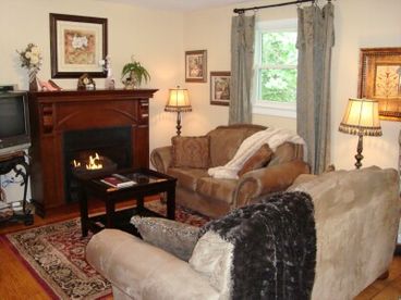 Enjoy the elegant gas log fireplace from your comfy sofas.  Open to kitchen and dining area.  