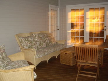 Outdoor screened in porch is perfect for an evening cocktail.  Porch offers a hammock for lounging or for those young at heart a ping pong table ready for a game of table tennis.