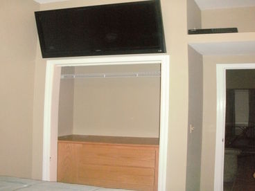 closet, drawers, and tv with cable 
