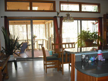 Kitchen, living room & eating area all open onto screened porch & deck.