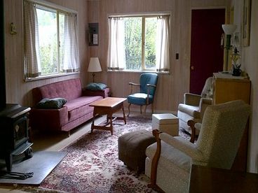 Rustic but comfortable old-fashioned easy chairs and sofa in the living room. 