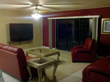 LIVING ROOM WITH WATERFRONT VIEW AND 65 INCH HD TV