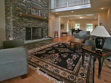 Living Room with Soaring Hand Laid Stone Fireplace
