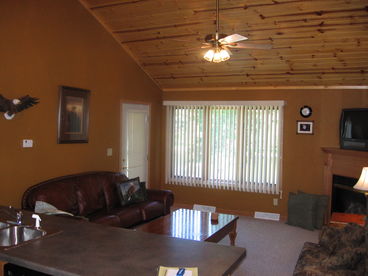 The living room of Eagle\'s Nest, an upper level unit, with a king bed in the master bedroom and two twin beds in the guest bedroom, features a cathedral ceiling and gas fireplace.
