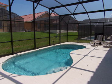 Private, screened pool with deck furniture