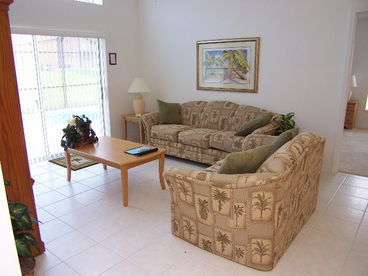 Family Room with sofa and love seat, flat screen tv, DVD, PS 2.