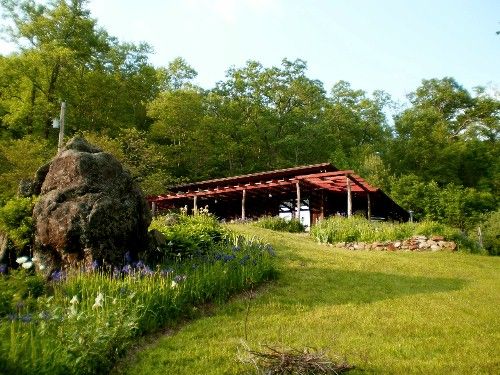 surrounded by acres of grassy hillside and gardens