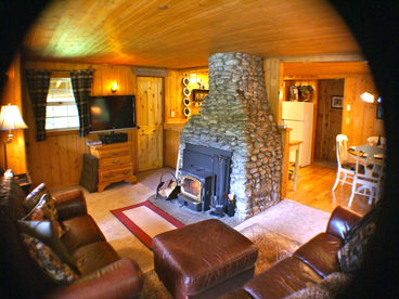 Warm living room with fireplace insert.  Leather couches and flat screen TV with HBO and Cinemax.