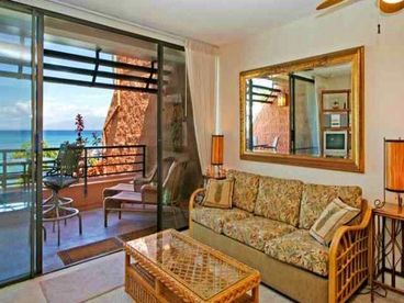 Our living room area looks directly out towards the Pacific. Lanai is to your left and Molokai is to your right. It\'s a fun room filled with lots of elegant Polynesia. The mirror has a wonderful way of playing with the oceans colors and light! It\'s quite a cozy and comfortable room.