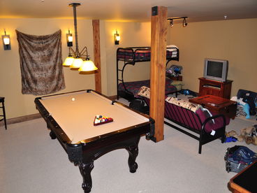 Bonus room features full size pool table, card table, wet bar with refrigerator and sink, and 2 double beds and one twin.